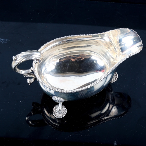 780 - An Edwardian silver sauce boat, gadrooned rim with shell feet and scrolled C-shape acanthus leaf han... 