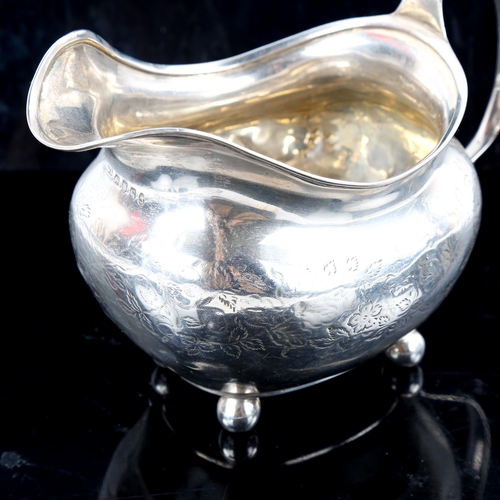 789 - A George III silver cream jug, bright-cut engraved floral decoration with gilt interior and bun feet... 