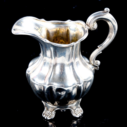 790 - A Victorian silver pumpkin cream jug, scrolled foliate feet with gilt interior, indistinct maker's m... 