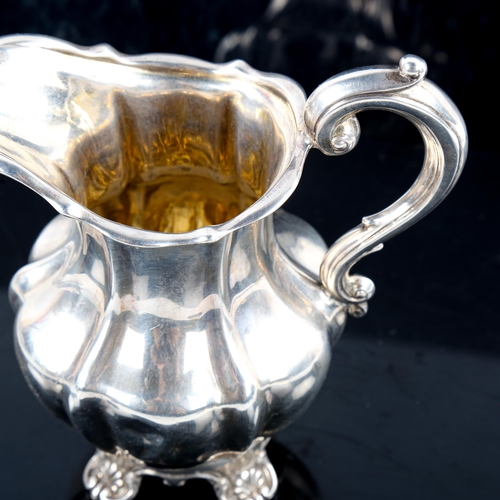 790 - A Victorian silver pumpkin cream jug, scrolled foliate feet with gilt interior, indistinct maker's m... 