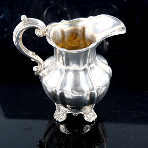 790 - A Victorian silver pumpkin cream jug, scrolled foliate feet with gilt interior, indistinct maker's m... 