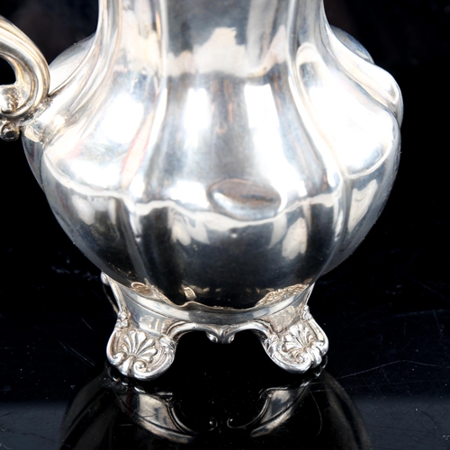 790 - A Victorian silver pumpkin cream jug, scrolled foliate feet with gilt interior, indistinct maker's m... 