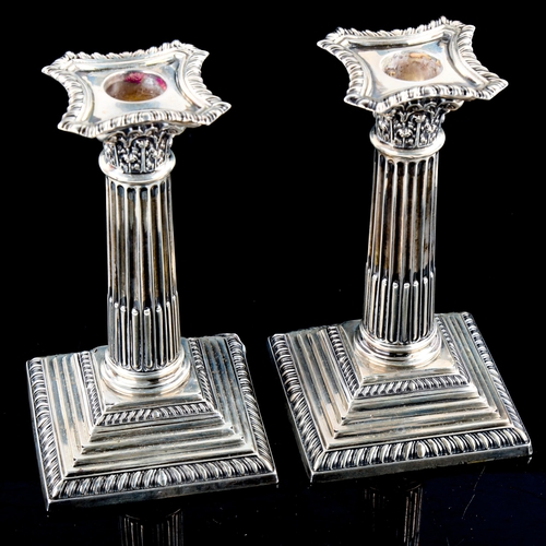 791 - ASPREY - a pair of George V silver squat Corinthian column table candlesticks, with removable sconce... 