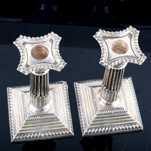 791 - ASPREY - a pair of George V silver squat Corinthian column table candlesticks, with removable sconce... 