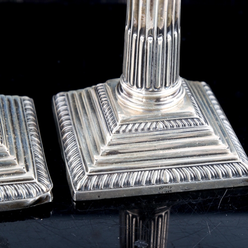 791 - ASPREY - a pair of George V silver squat Corinthian column table candlesticks, with removable sconce... 