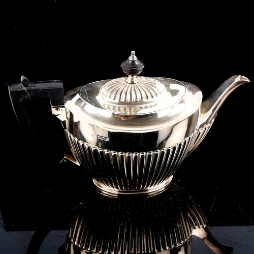 793 - A late Victorian silver teapot, oval half fluted form with turned ebony mounts, by John Round & Sons... 