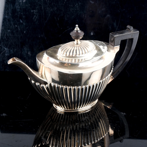 793 - A late Victorian silver teapot, oval half fluted form with turned ebony mounts, by John Round & Sons... 