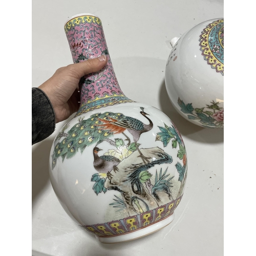 106 - A pair of Chinese porcelain narrow-neck bottle vases, decorated with peacocks and prunus and panels ... 