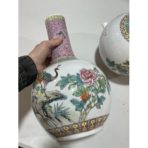 106 - A pair of Chinese porcelain narrow-neck bottle vases, decorated with peacocks and prunus and panels ... 