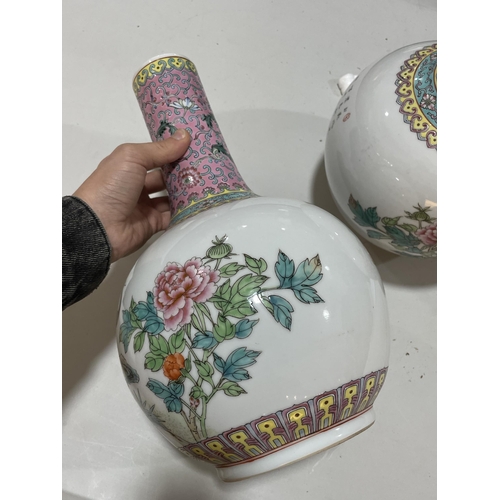 106 - A pair of Chinese porcelain narrow-neck bottle vases, decorated with peacocks and prunus and panels ... 