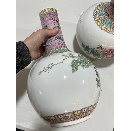 106 - A pair of Chinese porcelain narrow-neck bottle vases, decorated with peacocks and prunus and panels ... 