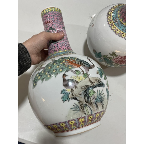 106 - A pair of Chinese porcelain narrow-neck bottle vases, decorated with peacocks and prunus and panels ... 