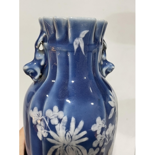 223 - A pair of Chinese blue glaze porcelain vases, with floral decoration, height 24cm