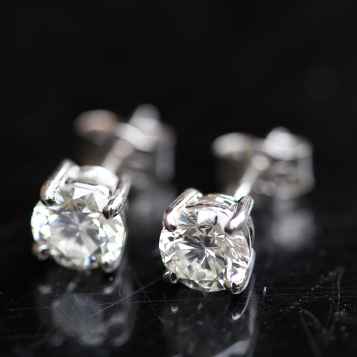 679 - A pair of modern 1.2ct solitaire diamond stud earrings, in 18ct white gold settings with modern roun... 