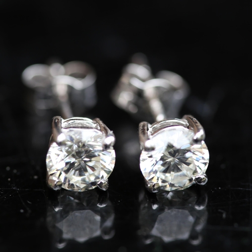 679 - A pair of modern 1.2ct solitaire diamond stud earrings, in 18ct white gold settings with modern roun... 