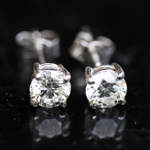 679 - A pair of modern 1.2ct solitaire diamond stud earrings, in 18ct white gold settings with modern roun... 