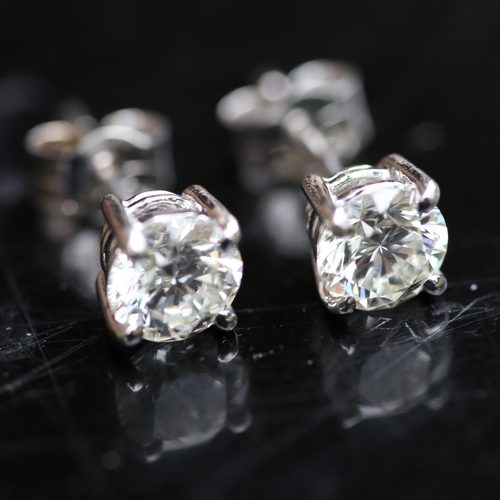 679 - A pair of modern 1.2ct solitaire diamond stud earrings, in 18ct white gold settings with modern roun... 