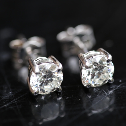 679 - A pair of modern 1.2ct solitaire diamond stud earrings, in 18ct white gold settings with modern roun... 