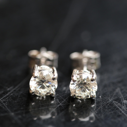 679 - A pair of modern 1.2ct solitaire diamond stud earrings, in 18ct white gold settings with modern roun... 