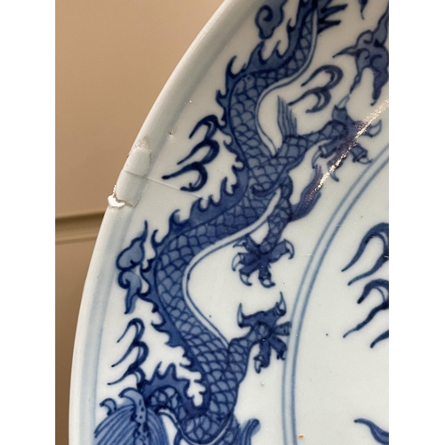 216 - A Chinese blue and white porcelain dragon bowl, 6 character mark, diameter 27cm