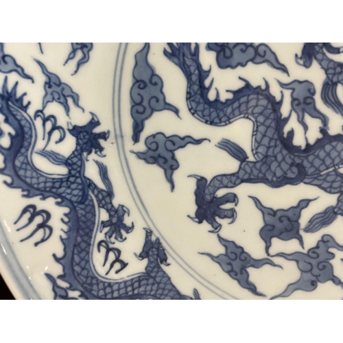 216 - A Chinese blue and white porcelain dragon bowl, 6 character mark, diameter 27cm