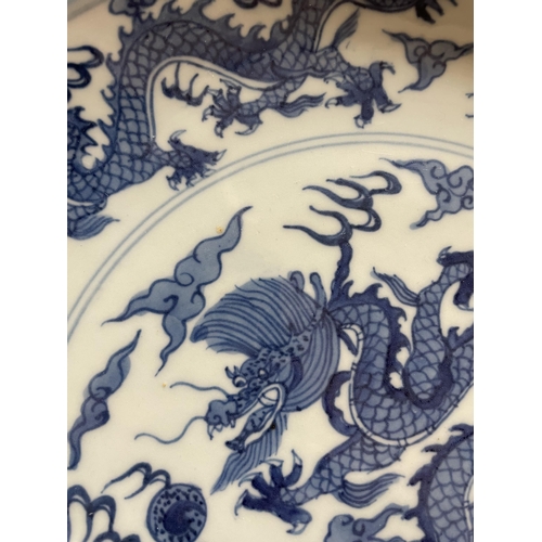 216 - A Chinese blue and white porcelain dragon bowl, 6 character mark, diameter 27cm