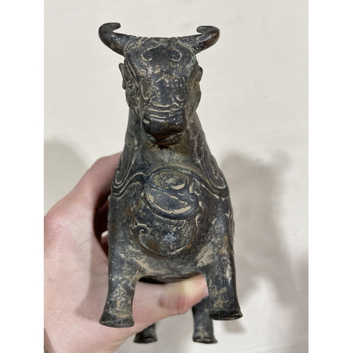 234 - A gilt patinated bronze bull, with relief moulded surface decoration, length 18cm