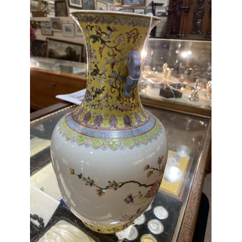 195 - A Chinese white glaze porcelain vase, finely painted enamel flowers with yellow ground neck, seal ma... 