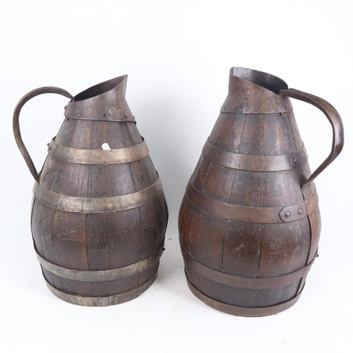 73 - A large graduated pair of coopered oak water flagons, largest height 46cm