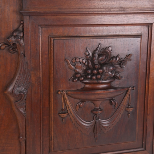 77 - 2 carved and stained mahogany panels, griffin monopodia and fruit with urn decoration, 49.5cm x 42cm