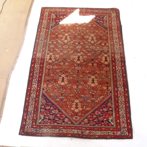 2406 - A red ground Persian Heriz rug, 207cm x 138cm