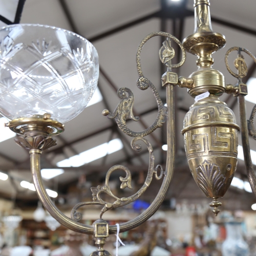 294 - A Regency style brass twin-branch chandelier, with glass shades, overall height approx 90cm, overall... 