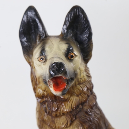 318 - An Art Deco style painted plaster sculpture, Alsatian on rocky outcrop, unsigned, height 50cm