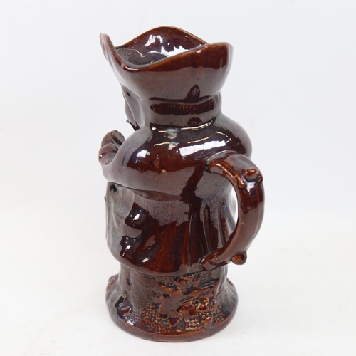 324 - A treacle-glaze snuff taker Toby jug, height 25cm