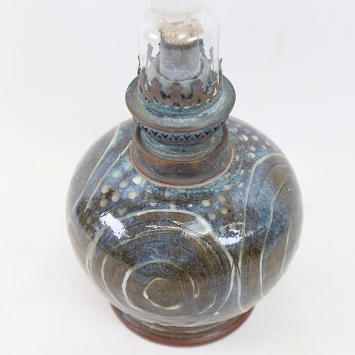 332 - An Art pottery oil lamp, signed, height 43cm