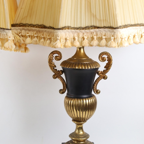 334 - A pair of black and gold urn design table lamps, with matching shades, height 88cm overall