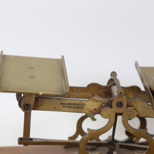 339 - Victorian brass postal scales, on mahogany stand, with weights, largest 1/2 lb