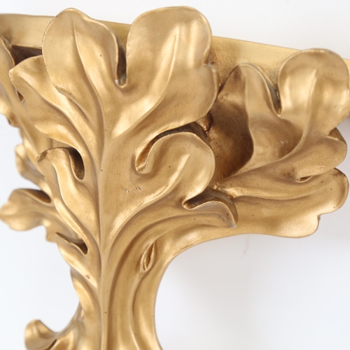 345 - A composition gilded wall bracket, with foliate design, height 28cm, and a small fluted wall bracket