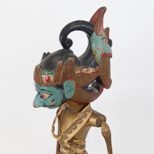 353 - An Eastern carved and painted wood puppet, mounted on plinth, 60cm overall