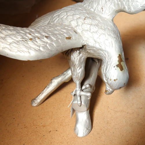 376 - A silvered metal figure of an eagle on a branch, height 52cm