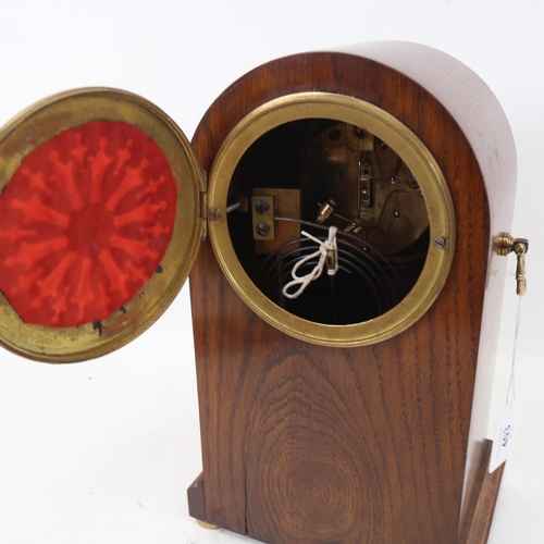 403 - An early 20th century oak-cased 8-day dome-top mantel clock, with brass carrying handles and movemen... 