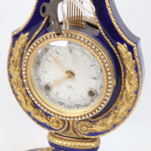 408 - A replica Marie-Antoinette clock from the Victoria & Albert Museum, gilded blue glaze porcelain in l... 