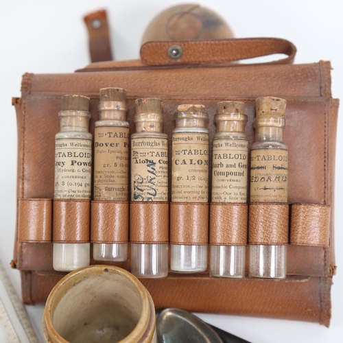 452 - A small pill maker, turned wood lidded pots, leather-cased glass medicinal powders, toothbrush etc