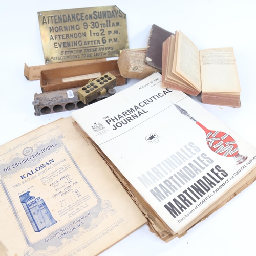 453 - A brass Pharmacy plaque, pharmaceutical journals, boxed moulds etc