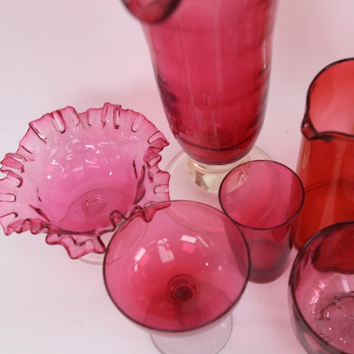 461 - A pair of cranberry glass vases with wavy rims, a jug, 18cm, and other cranberry glassware