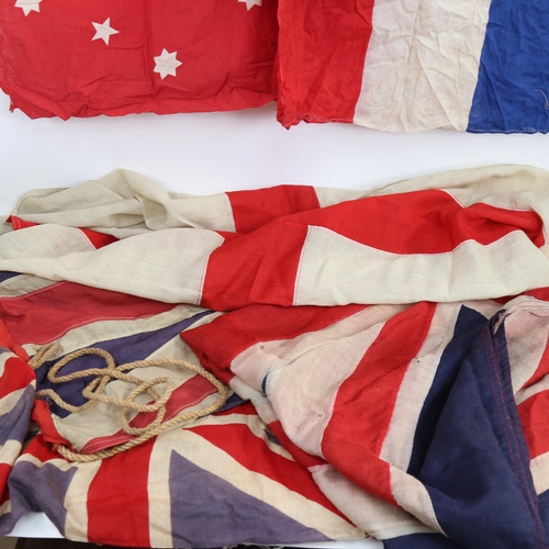 513 - A collection of Vintage flags, including Union Jacks, various sizes