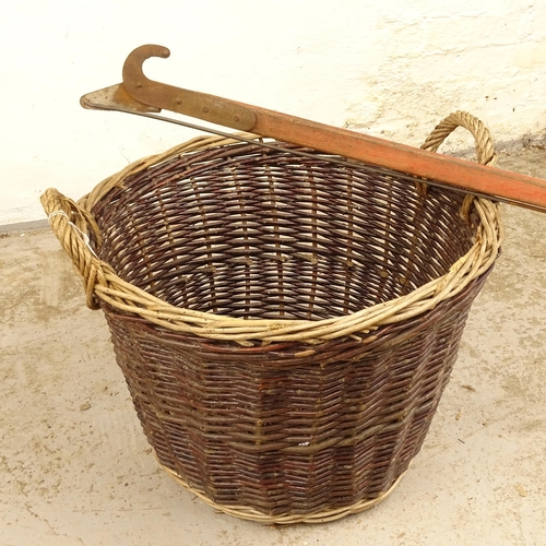 2710 - A wicker 2-handled basket, and a long-reach lopper