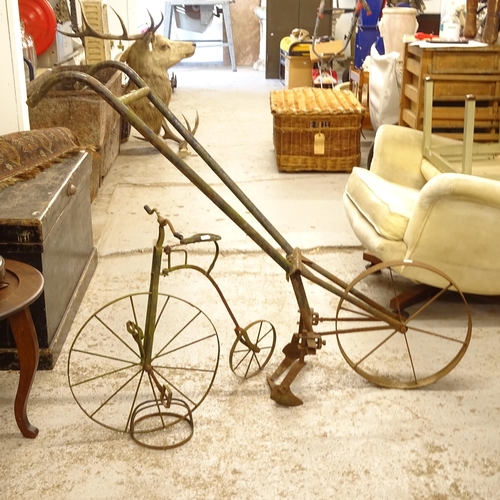 2729 - An ornamental wrought-iron penny-farthing, H59cm, and a small iron plough