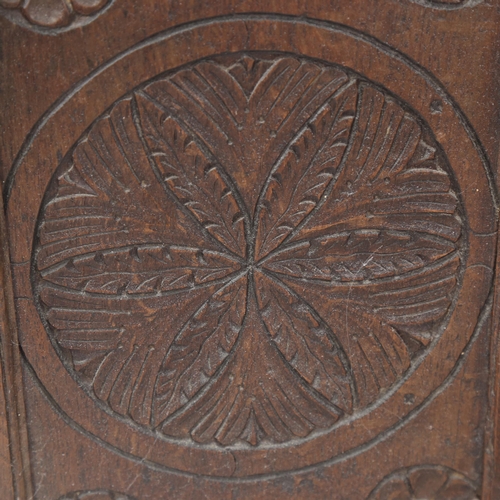 610 - A folding carved oak screen, decorated with florets and foliage, height 65cm