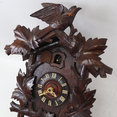 746 - A Vintage Black Forest oak cuckoo clock, with pine cone weights, clock height 45cm